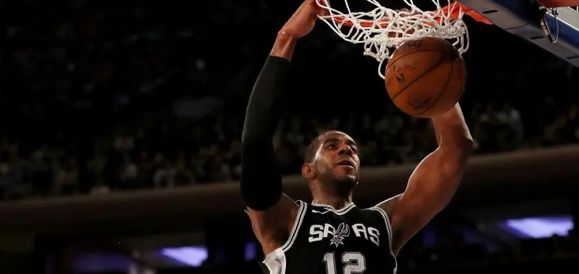 NEW YORK, NEW YORK - JANUARY 02: LaMarcus Aldridge #12 of the San Antonio Spurs dunks the ball as Michael Beasley #8 of the New York Knicks defends in the second half at Madison Square Garden on January 02, 2018 in New York City