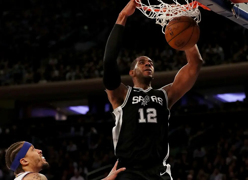 NEW YORK, NEW YORK - JANUARY 02: LaMarcus Aldridge #12 of the San Antonio Spurs dunks the ball as Michael Beasley #8 of the New York Knicks defends in the second half at Madison Square Garden on January 02, 2018 in New York City