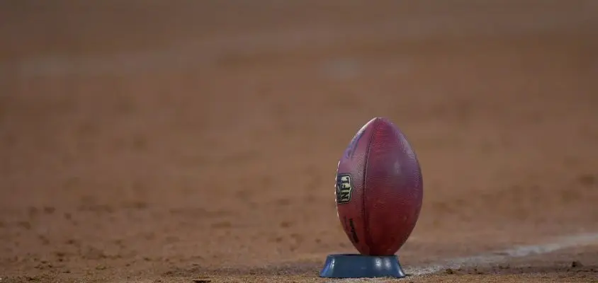 OAKLAND, CA - AUGUST 24: A detailed view of an official NFL football on a kicking T prior to the start of a NFL preseason football game between the Green Bay Packers and Oakland Raiders at Oakland-Alameda County Coliseum on August 24, 2018 in Oakland, California.