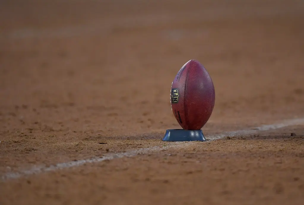 OAKLAND, CA - AUGUST 24: A detailed view of an official NFL football on a kicking T prior to the start of a NFL preseason football game between the Green Bay Packers and Oakland Raiders at Oakland-Alameda County Coliseum on August 24, 2018 in Oakland, California.