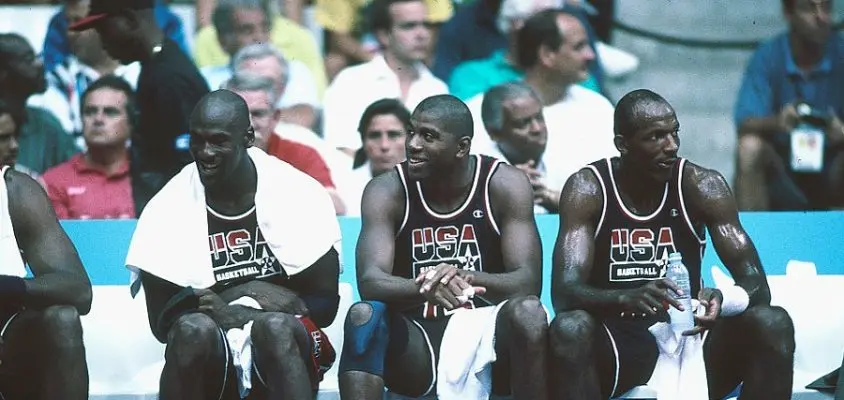 1992: Michael Jordan (L), Magic Johnson (M) and Clyde Drexler (R) of Team USA, the Dream Team, sit on the bench during the men's basketball competition at the 1992 Summer Olympics in Barcelona, Spain.