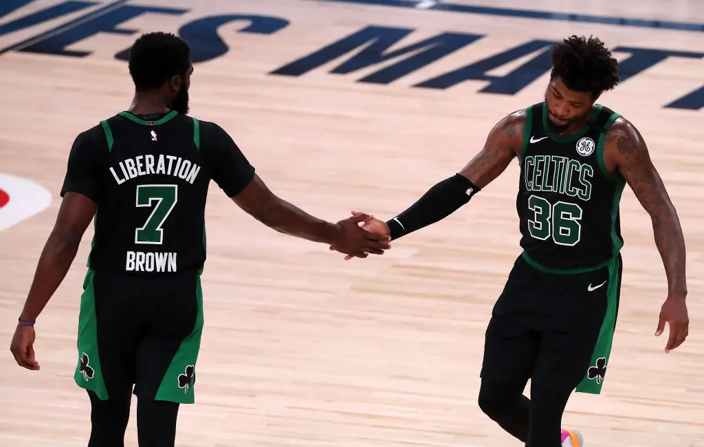 LAKE BUENA VISTA, FLORIDA - SEPTEMBER 11: Jaylen Brown #7 of the Boston Celtics and Marcus Smart #36 of the Boston Celtics react during the fourth quarter against the Toronto Raptors in Game Seven of the Eastern Conference Second Round during the 2020 NBA Playoffs at AdventHealth Arena at the ESPN Wide World Of Sports Complex on September 11, 2020 in Lake Buena Vista, Florida