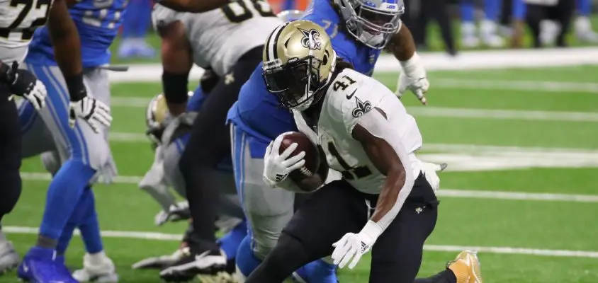 DETROIT, MICHIGAN - OCTOBER 04: Alvin Kamara #41 of the New Orleans Saints tries to get past the tackle of Danny Shelton #71 of the Detroit Lions at Ford Field on October 04, 2020 in Detroit, Michigan. New Orleans won the game 35-29