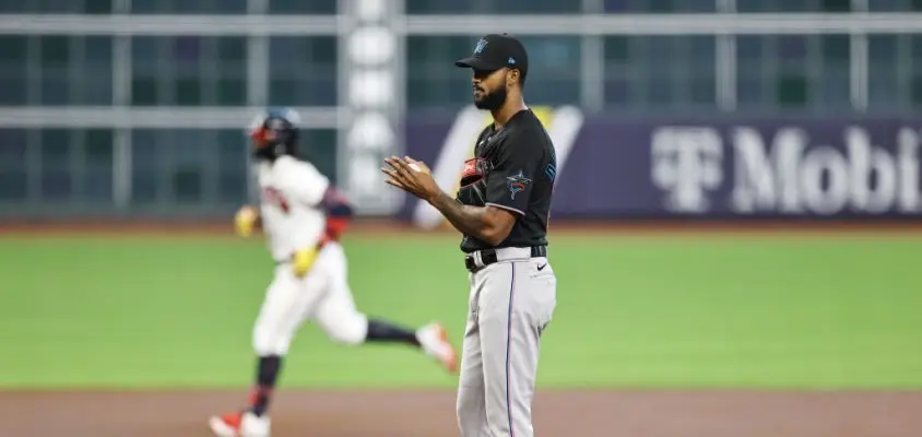 HOUSTON, TEXAS - OCTOBER 06: Sandy Alcantara #22 of the Miami Marlins looks on as Ronald Acuna Jr. #13 of the Atlanta Braves runs the bases after hitting a homerun during the first inning in Game One of the National League Division Series at Minute Maid Park on October 06, 2020 in Houston, Texas