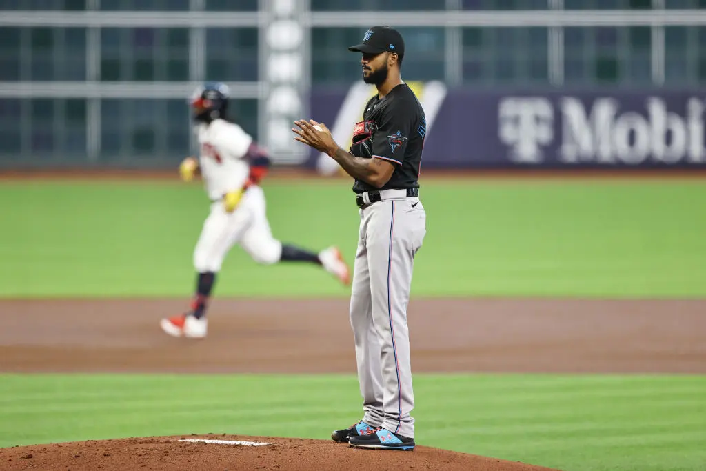 HOUSTON, TEXAS - OCTOBER 06: Sandy Alcantara #22 of the Miami Marlins looks on as Ronald Acuna Jr. #13 of the Atlanta Braves runs the bases after hitting a homerun during the first inning in Game One of the National League Division Series at Minute Maid Park on October 06, 2020 in Houston, Texas