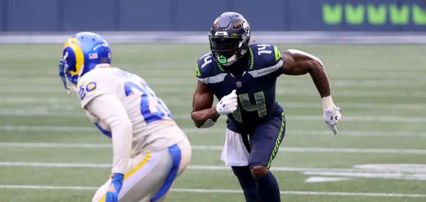 SEATTLE, WASHINGTON - DECEMBER 27: DK Metcalf #14 of the Seattle Seahawks and Jalen Ramsey #20 of the Los Angeles Rams in action during the second quarter at Lumen Field on December 27, 2020 in Seattle, Washington.