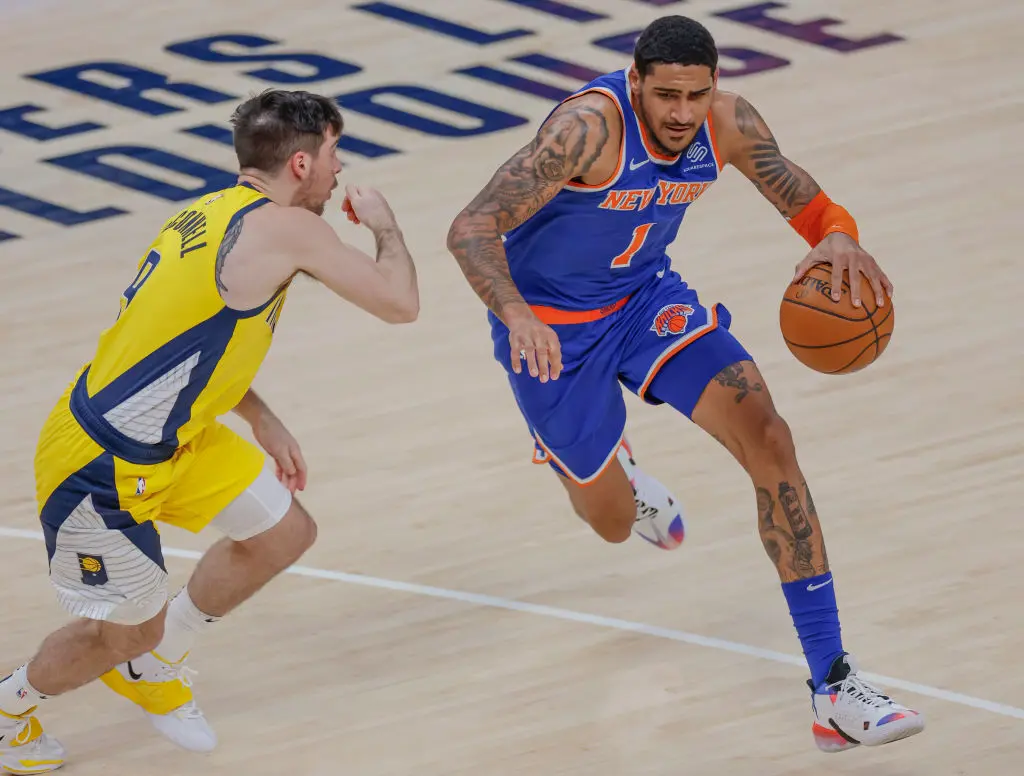 INDIANAPOLIS, IN - DECEMBER 23: Obi Toppin #1 of the New York Knicks brings the ball up court against T.J. McConnell #9 of the Indiana Pacers at Bankers Life Fieldhouse on December 23, 2020 in Indianapolis, Indiana