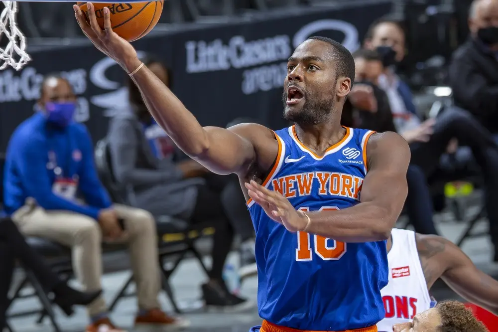 DETROIT, MI - DECEMBER 13: Alec Burks #18 of the New York Knicks drives to the basket in front of Blake Griffin #23 of the Detroit Pistons in the first half of an NBA game at Little Caesars Arena on December 13, 2020 in Detroit, Michigan