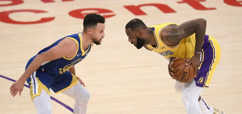 LOS ANGELES, CALIFORNIA - JANUARY 18: LeBron James #23 of the Los Angeles Lakers is guarded by Stephen Curry #30 of the Golden State Warriors during the first half at Staples Center on January 18, 2021 in Los Angeles, California. NOTE TO USER: User expressly acknowledges and agrees that, by downloading and/or using this Photograph, user is consenting to the terms and conditions of the Getty Images License Agreement. Mandatory Copyright Notice: Copyright 2021 NBAE