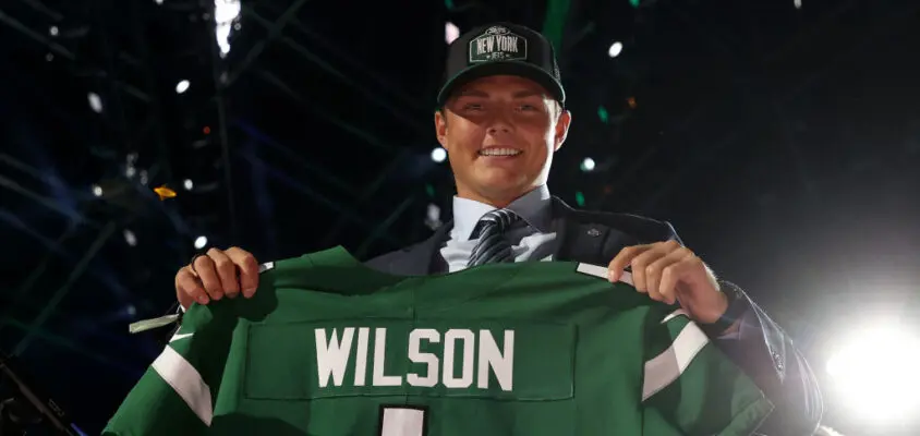 CLEVELAND, OHIO - APRIL 29: Zach Wilson holds a jersey onstage after being drafted second by the New York Jets during round one of the 2021 NFL Draft at the Great Lakes Science Center on April 29, 2021 in Cleveland, Ohio