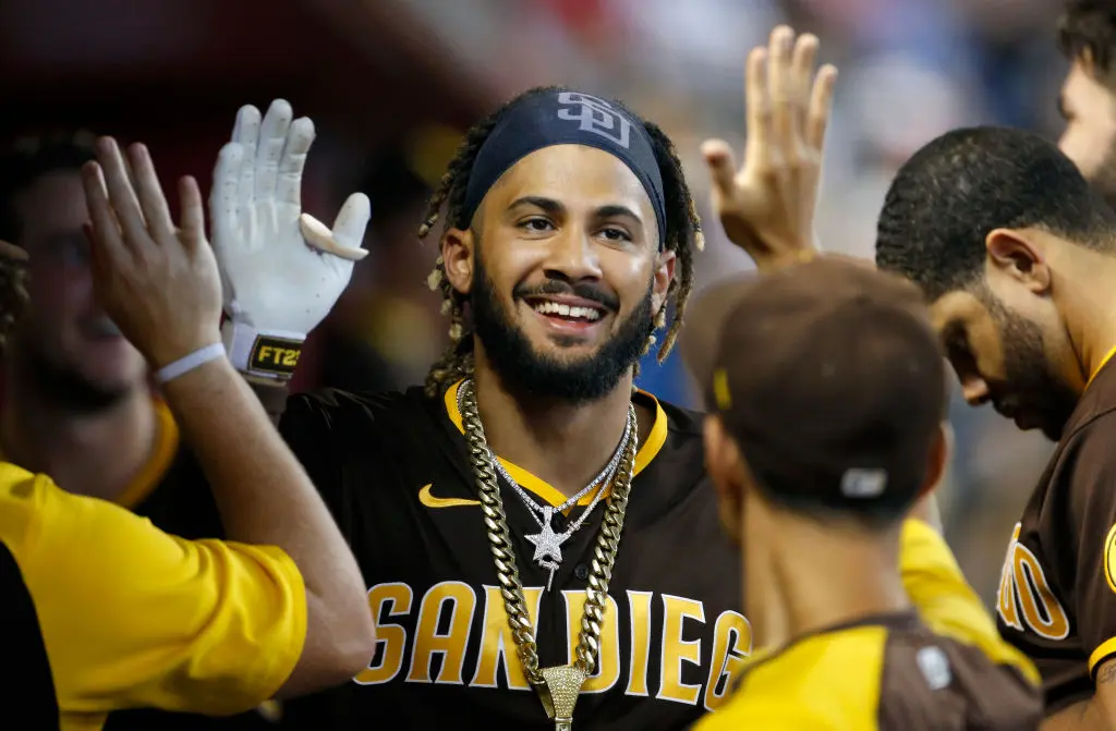 PHOENIX, ARIZONA - AUGUST 15: Fernando Tatis Jr #23 of the San Diego Padres is congratulated by teammates after hitting a solo home run against the Arizona Diamondbacks during the fifth inning of the MLB game at Chase Field on August 15, 2021 in Phoenix, Arizona. It was Tatis' second homer of the game