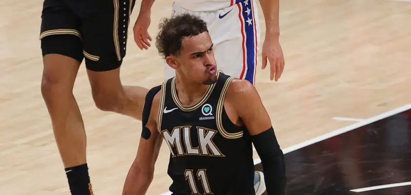 ATLANTA, GEORGIA - JUNE 18: Trae Young #11 of the Atlanta Hawks reacts after hitting a three-point basket against the Philadelphia 76ers during the first half of game 6 of the Eastern Conference Semifinals at State Farm Arena on June 18, 2021 in Atlanta, Georgia.