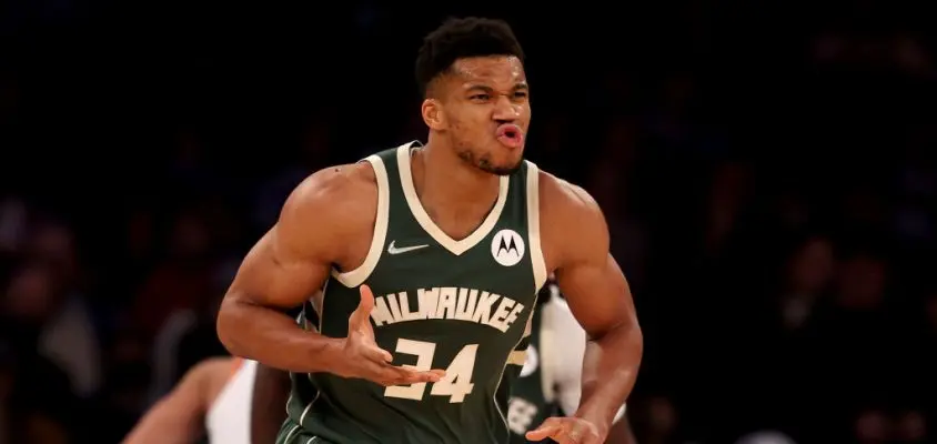 NEW YORK, NEW YORK - DECEMBER 12: Giannis Antetokounmpo #34 of the Milwaukee Bucks celebrates after teammate Bobby Portis #9 made a shot off his assist in the first half at Madison Square Garden on December 12, 2021 in New York City