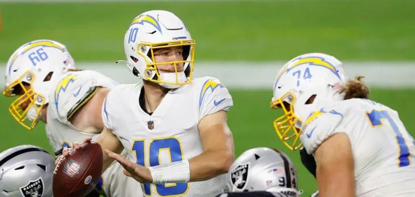 LAS VEGAS, NEVADA - DECEMBER 17: Quarterback Justin Herbert #10 of the Los Angeles Chargers drops back to pass during the third quarter of the NFL game against the Las Vegas Raiders at Allegiant Stadium on December 17, 2020 in Las Vegas, Nevada. The Chargers defeated the Raiders in overtime 30-27