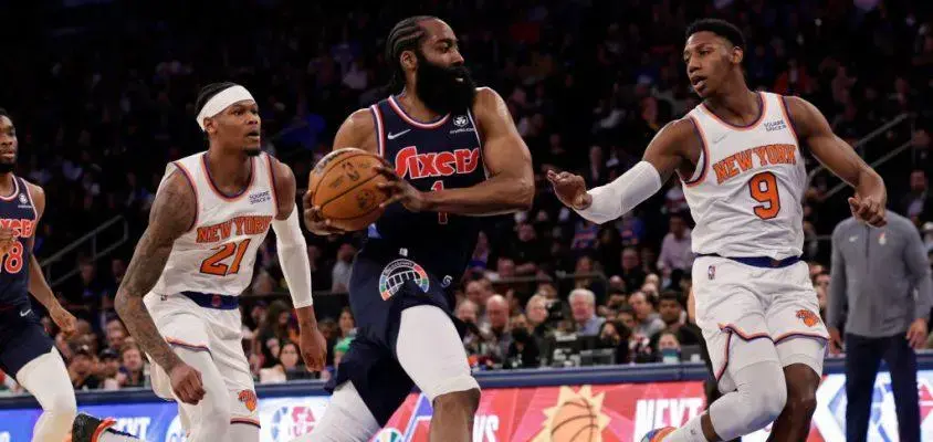 NEW YORK, NEW YORK - FEBRUARY 27: James Harden #1 of the Philadelphia 76ers drives to the basket past RJ Barrett #9 of the New York Knicks during the first half at Madison Square Garden on February 27, 2022 in New York City.