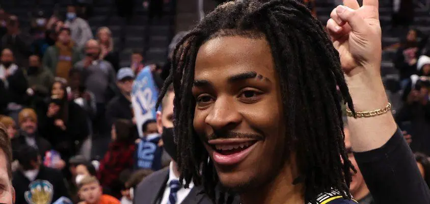 DETROIT, MICHIGAN - FEBRUARY 10: Ja Morant #12 of the Memphis Grizzlies signs autographs after a 132-107 win over the Detroit Pistons at Little Caesars Arena on February 10, 2022 in Detroit, Michigan.