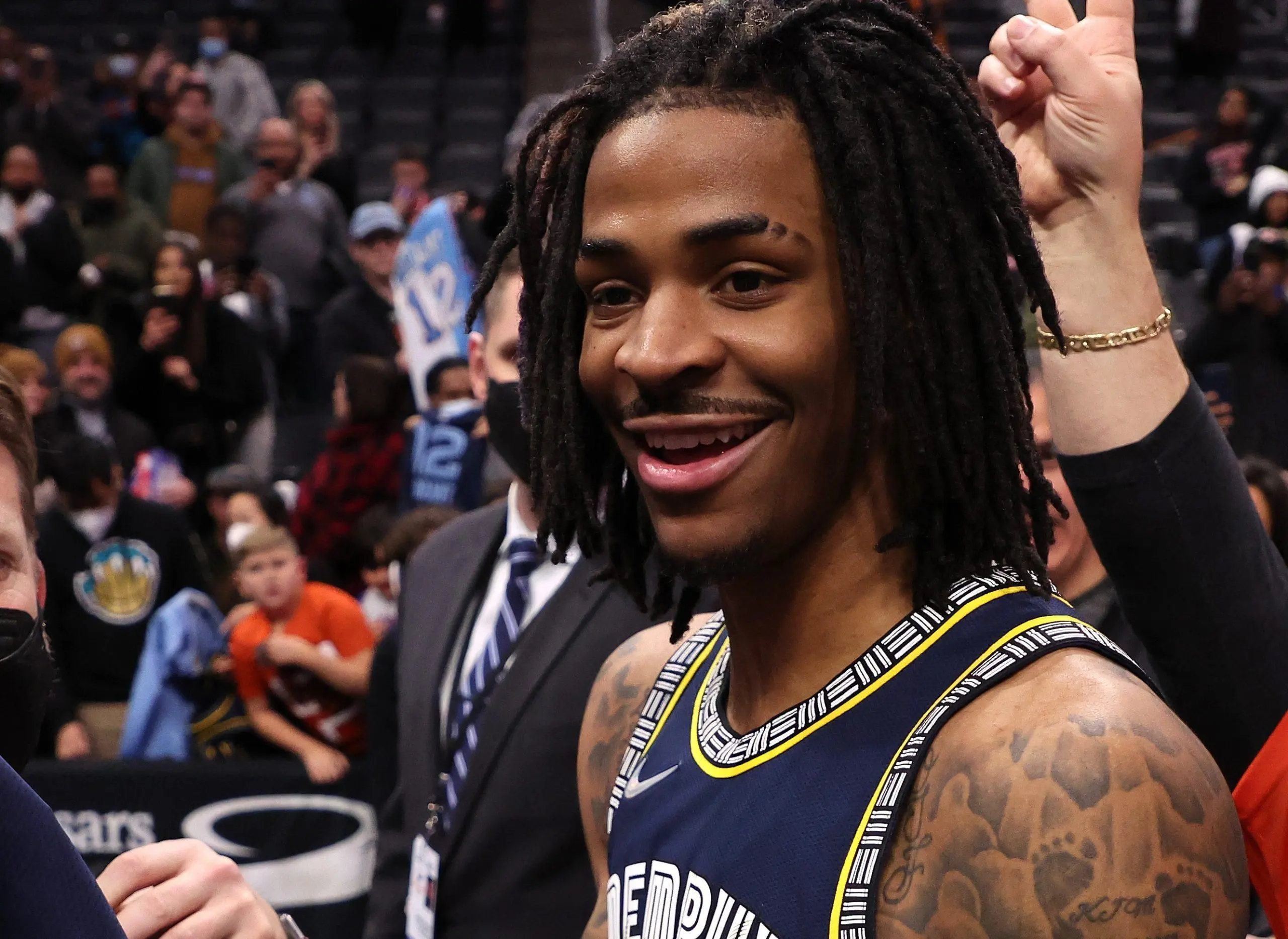 DETROIT, MICHIGAN - FEBRUARY 10: Ja Morant #12 of the Memphis Grizzlies signs autographs after a 132-107 win over the Detroit Pistons at Little Caesars Arena on February 10, 2022 in Detroit, Michigan.