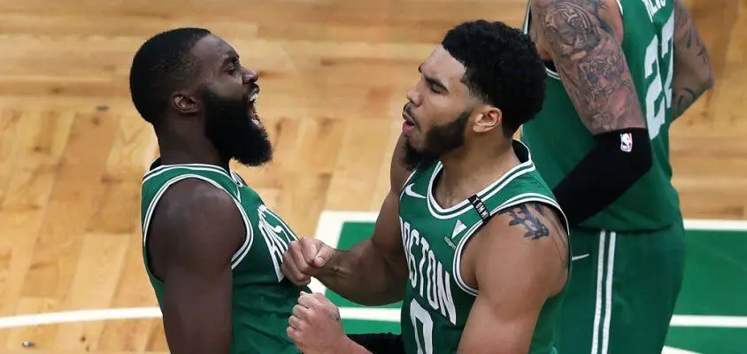 BOSTON - DECEMBER 23: Boston Celtics' Jayson Tatum, right, is chest bumped by teammate Jaylen Brown after Tatum hit a three point shot that won the game. The Boston Celtics host the Milwaukee Bucks in the opening game of the NBA regular season at the TD Garden in Boston on Dec. 23, 2020.