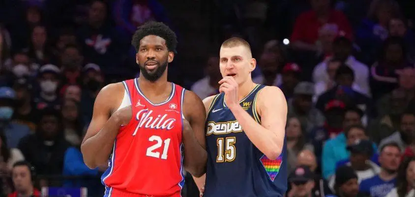 PHILADELPHIA, PA - MARCH 14: Joel Embiid #21 of the Philadelphia 76ers talks to Nikola Jokic #15 of the Denver Nuggets at the Wells Fargo Center on March 14, 2022 in Philadelphia, Pennsylvania. The Nuggets defeated the 76ers 114-110