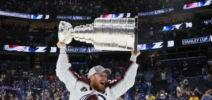 TAMPA, FLORIDA - JUNE 26: Gabriel Landeskog #92 of the Colorado Avalanche carries the Stanley Cup following the series winning victory over the Tampa Bay Lightning in Game Six of the 2022 NHL Stanley Cup Final at Amalie Arena on June 26, 2022 in Tampa, Florida