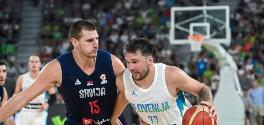 LJUBJLANA, SLOVENIA - 2022/08/17: Nikola Jokic #15 of Serbia and Luka Doncic #77 of Slovenia in action during the International Friendly basketball between Slovenia and Serbia at Arena Stozice. Final score after extra time was Slovenia 97: 92 Serbia