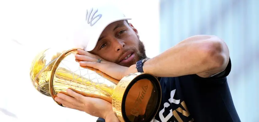 SAN FRANCISCO, CALIFORNIA - JUNE 20: Stephen Curry #30 of the Golden State Warriors celebrates with his NBA Finals Most Valuable Player Award during the Golden State Warriors Victory Parade on June 20, 2022 in San Francisco, California. The Golden State Warriors beat the Boston Celtics 4-2 to win the 2022 NBA Finals.