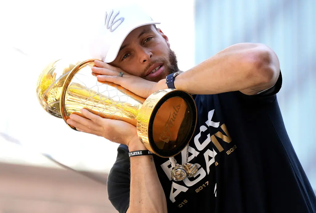 SAN FRANCISCO, CALIFORNIA - JUNE 20: Stephen Curry #30 of the Golden State Warriors celebrates with his NBA Finals Most Valuable Player Award during the Golden State Warriors Victory Parade on June 20, 2022 in San Francisco, California. The Golden State Warriors beat the Boston Celtics 4-2 to win the 2022 NBA Finals.