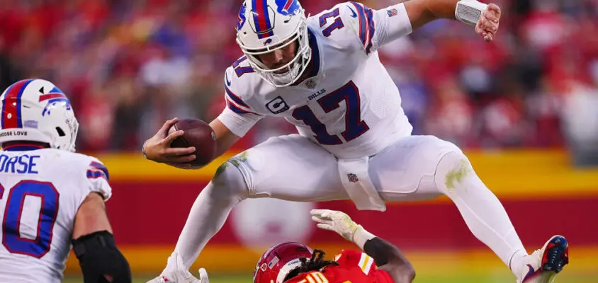 KANSAS CITY, MISSOURI - OCTOBER 16: Josh Allen #17 of the Buffalo Bills hurdles over Justin Reid #20 of the Kansas City Chiefs during the fourth quarter at Arrowhead Stadium on October 16, 2022 in Kansas City, Missouri