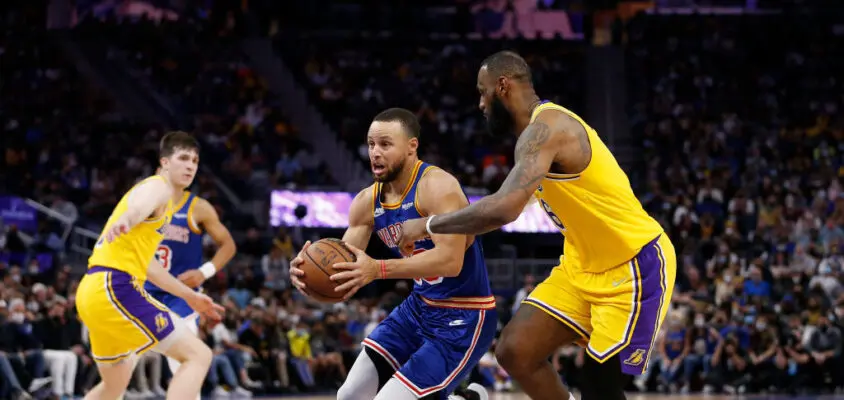 SAN FRANCISCO, CALIFORNIA - FEBRUARY 12: Stephen Curry #30 of the Golden State Warriors drives to the basket against LeBron James #6 of the Los Angeles Lakers in the second half at Chase Center on February 12, 2022 in San Francisco, California.