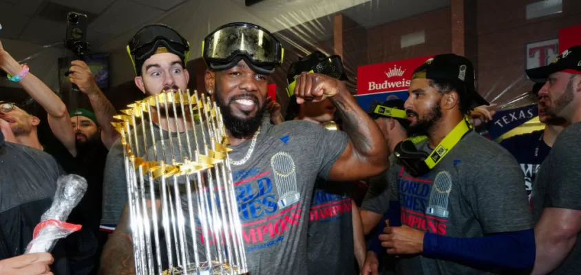 PHOENIX, AZ - NOVEMBER 01: Adolis García #53 of the Texas Rangers celebrates in the clubhouse with the commissioner's trophy after Game 5 of the 2023 World Series between the Texas Rangers and the Arizona Diamondbacks at Chase Field on Wednesday, November 1, 2023 in Phoenix, Arizona.