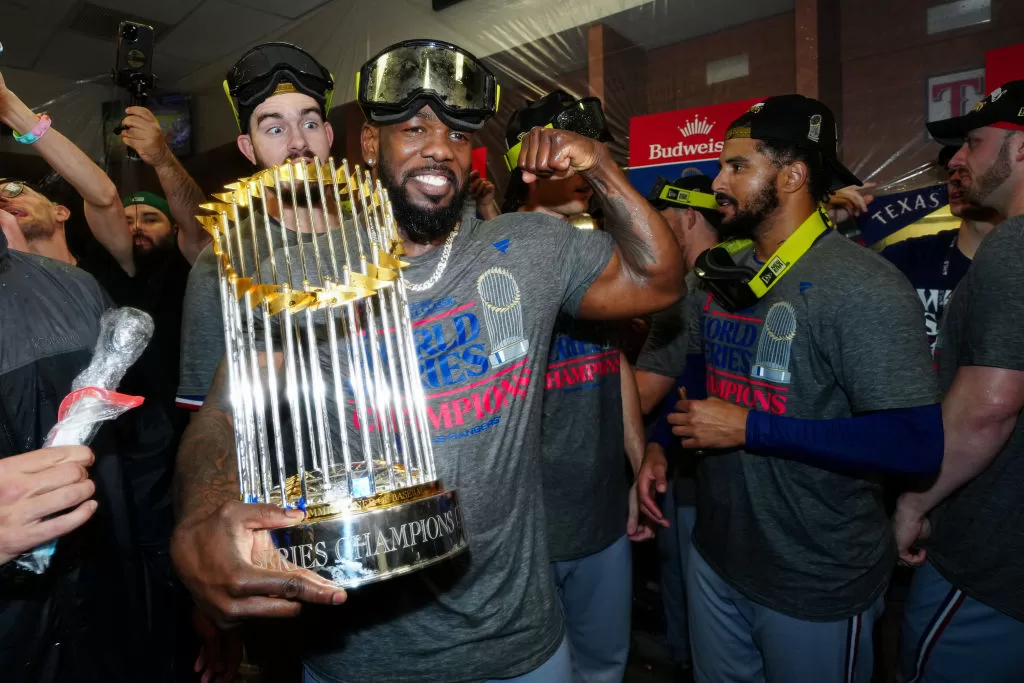 PHOENIX, AZ - NOVEMBER 01: Adolis García #53 of the Texas Rangers celebrates in the clubhouse with the commissioner's trophy after Game 5 of the 2023 World Series between the Texas Rangers and the Arizona Diamondbacks at Chase Field on Wednesday, November 1, 2023 in Phoenix, Arizona.