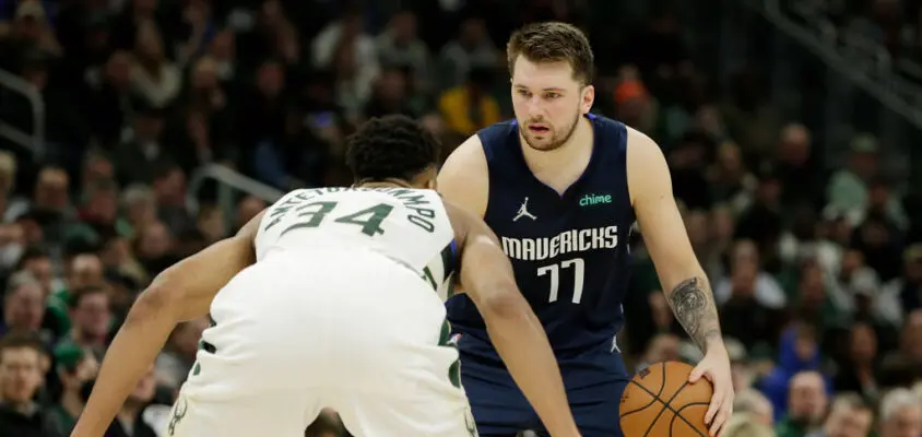 MILWAUKEE, WISCONSIN - APRIL 03: Luka Doncic #77 of the Dallas Mavericks dribbles up court while being defended by Giannis Antetokounmpo #34 of the Milwaukee Bucks during the second half of a game at Fiserv Forum on April 03, 2022 in Milwaukee, Wisconsin