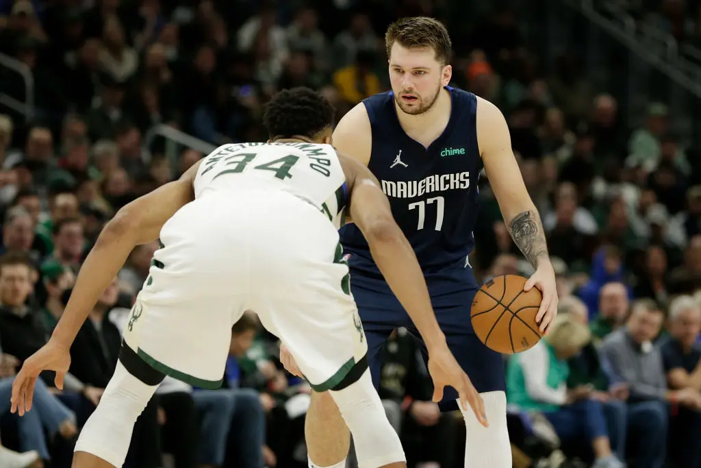 MILWAUKEE, WISCONSIN - APRIL 03: Luka Doncic #77 of the Dallas Mavericks dribbles up court while being defended by Giannis Antetokounmpo #34 of the Milwaukee Bucks during the second half of a game at Fiserv Forum on April 03, 2022 in Milwaukee, Wisconsin