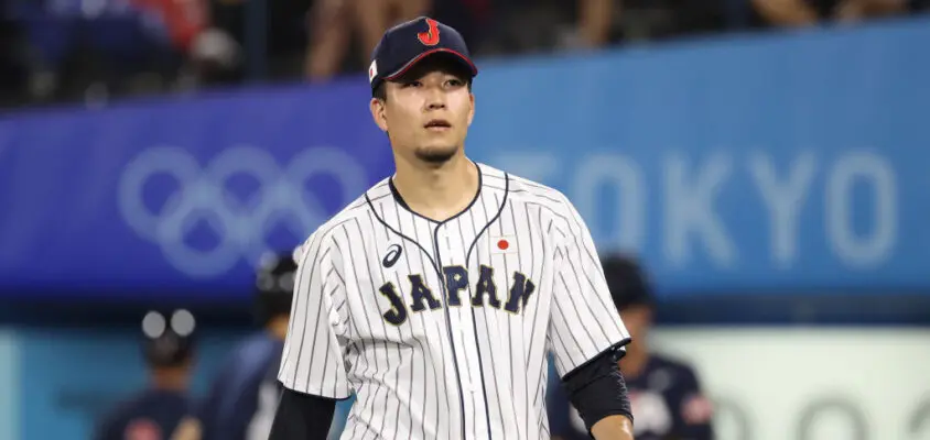 YOKOHAMA, JAPAN - AUGUST 07: Pitcher Kodai Senga #21 of Team Japan reacts after the sixth inning against Team United Staes during the gold medal game between Team United States and Team Japan on day fifteen of the Tokyo 2020 Olympic Games at Yokohama Baseball Stadium on August 07, 2021 in Yokohama, Kanagawa, Japan