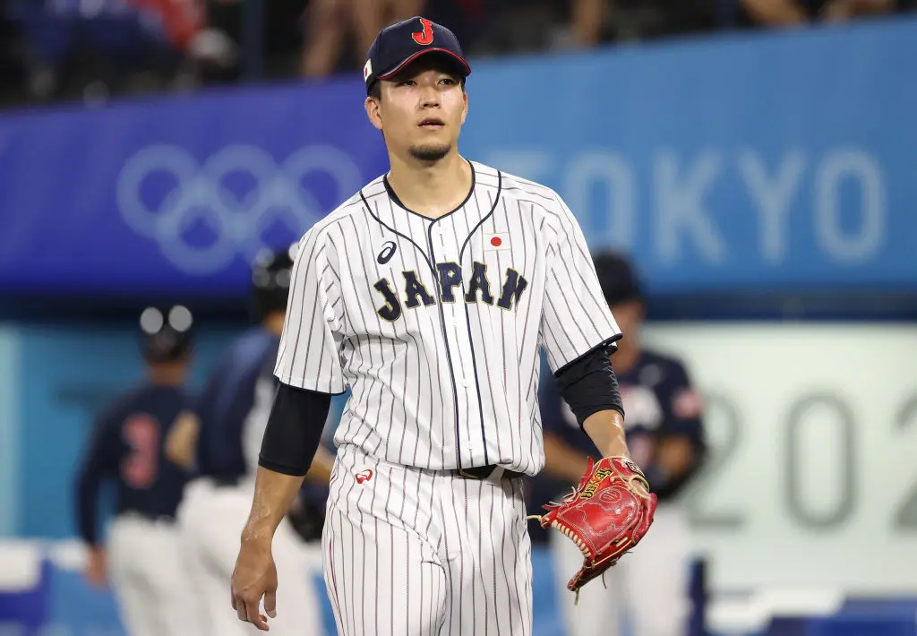 YOKOHAMA, JAPAN - AUGUST 07: Pitcher Kodai Senga #21 of Team Japan reacts after the sixth inning against Team United Staes during the gold medal game between Team United States and Team Japan on day fifteen of the Tokyo 2020 Olympic Games at Yokohama Baseball Stadium on August 07, 2021 in Yokohama, Kanagawa, Japan