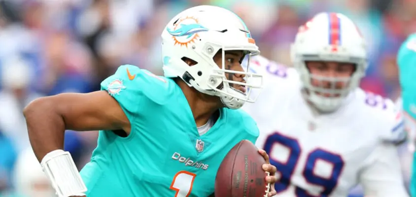 ORCHARD PARK, NEW YORK - OCTOBER 31: Tua Tagovailoa #1 of the Miami Dolphins scrambles in the third quarter against the Buffalo Bills at Highmark Stadium on October 31, 2021 in Orchard Park, New York