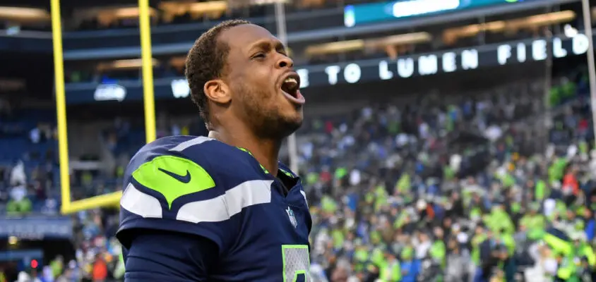 SEATTLE, WASHINGTON - JANUARY 08: Geno Smith #7 of the Seattle Seahawks celebrates after defeating the Los Angeles Rams in overtime at Lumen Field on January 08, 2023 in Seattle, Washington