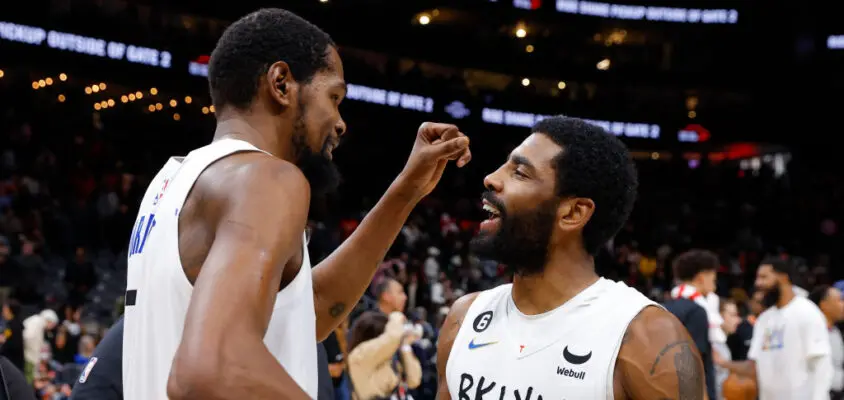 ATLANTA, GA - DECEMBER 28: Kevin Durant #7 of the Brooklyn Nets reacts withy Kyrie Irving #11 after their 108-107 victory over the Atlanta Hawks at State Farm Arena on December 28, 2022 in Atlanta, Georgia.