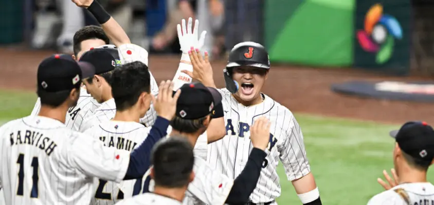 MIAMI, FLORIDA - MARCH 21: Munetaka Murakami #55 of Team Japan celebrates with teammates after hitting a solo home run in the bottom of the second inning during World Baseball Classic Championship between United States and Japan at loanDepot park on March 21, 2023 in Miami, Florida