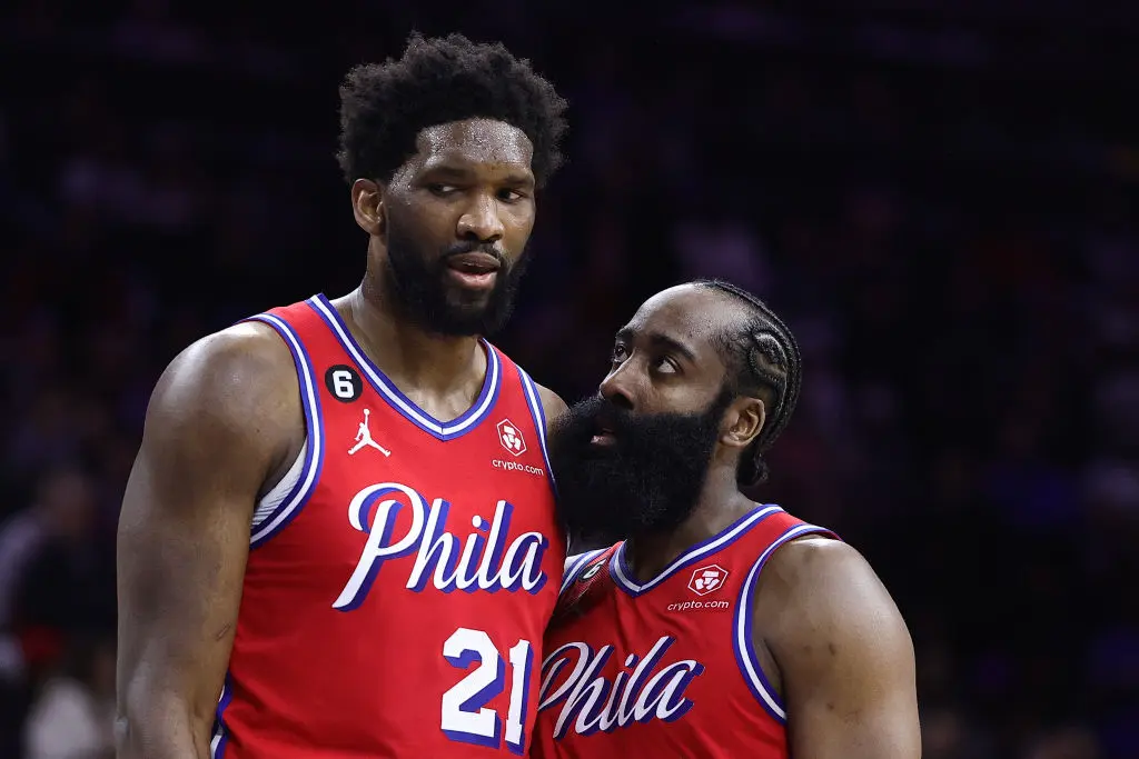 PHILADELPHIA, PENNSYLVANIA - DECEMBER 23: Joel Embiid #21 and James Harden #1 of the Philadelphia 76ers speak during the fourth quarter against the LA Clippers at Wells Fargo Center on December 23, 2022 in Philadelphia, Pennsylvania.