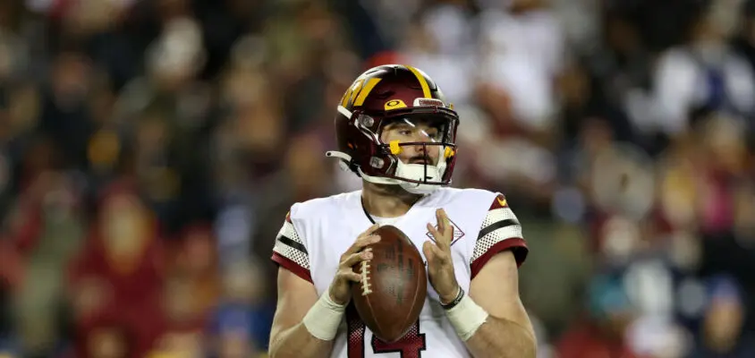 LANDOVER, MARYLAND - JANUARY 08: Quarterback Sam Howell #14 of the Washington Commanders drops back to pass against the Dallas Cowboys at FedExField on January 08, 2023 in Landover, Maryland