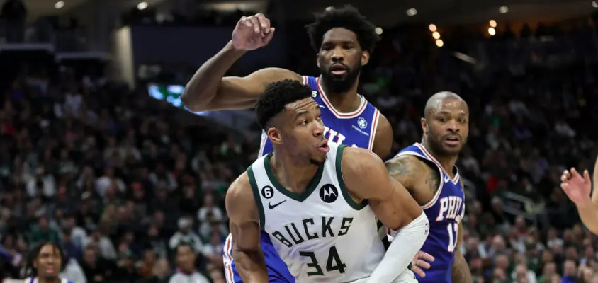 MILWAUKEE, WISCONSIN - APRIL 02: Giannis Antetokounmpo #34 of the Milwaukee Bucks is defended by Joel Embiid #21 of the Philadelphia 76ers during the first half of a game at Fiserv Forum on April 02, 2023 in Milwaukee, Wisconsin.