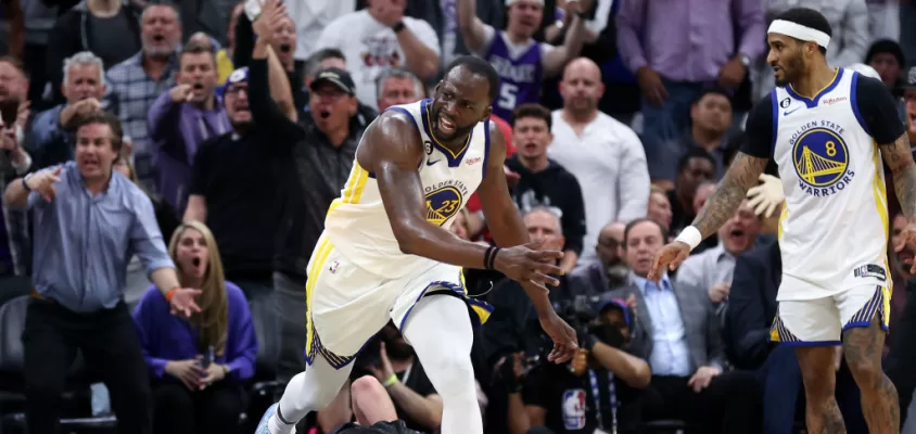 SACRAMENTO, CALIFORNIA - APRIL 17: Draymond Green #23 of the Golden State Warriors steps over Domantas Sabonis #10 of the Sacramento Kings in the second half during Game Two of the Western Conference First Round Playoffs at Golden 1 Center on April 17, 2023 in Sacramento, California. Green was issued a flagrant foul 2 on the play, and ejected from the game.