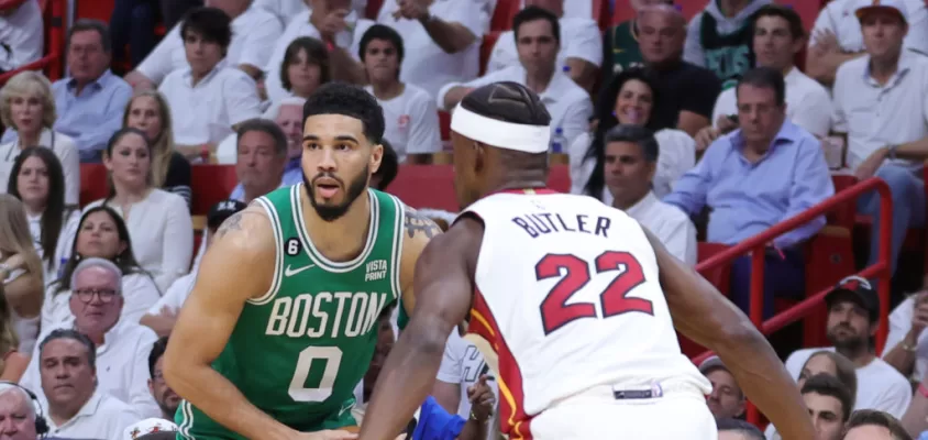 MIAMI, FLORIDA - MAY 23: Jayson Tatum #0 of the Boston Celtics controls the ball ahead of Jimmy Butler #22 of the Miami Heat during the first quarter in game four of the Eastern Conference Finals at Kaseya Center on May 23, 2023 in Miami, Florida.