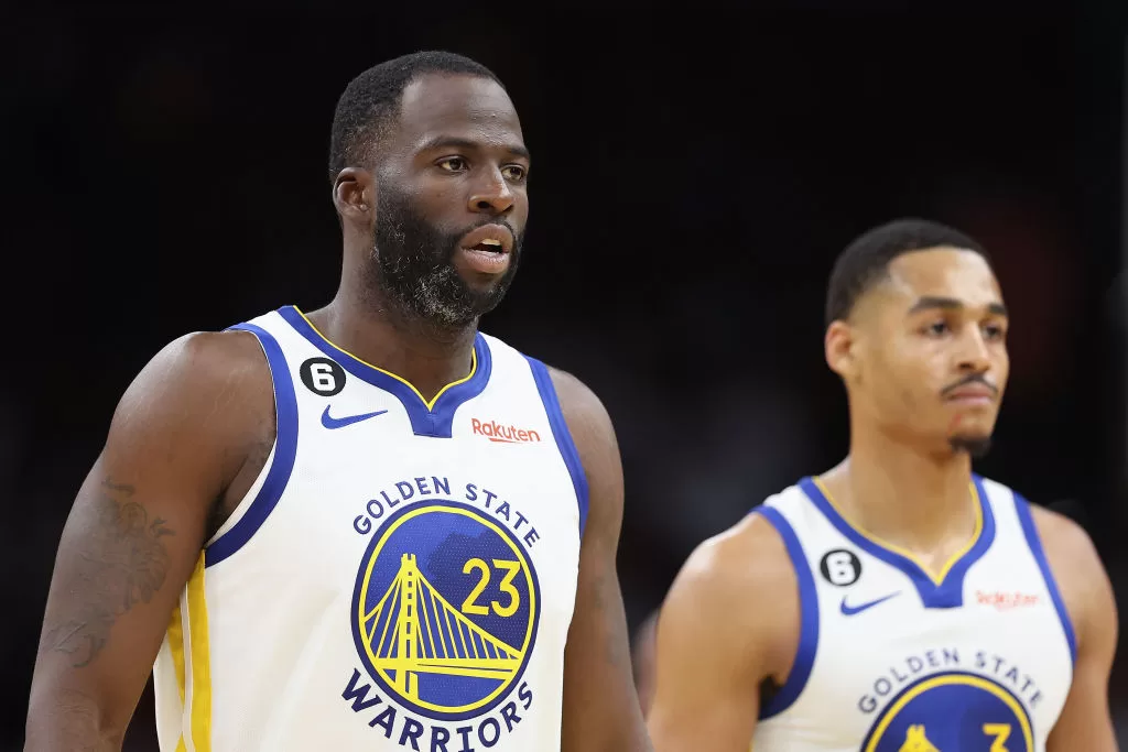 PHOENIX, ARIZONA - OCTOBER 25: (L-R) Draymond Green #23 and Jordan Poole #3 of the Golden State Warriors walk to the bench during the second half of the NBA game against the Phoenix Suns at Footprint Center on October 25, 2022 in Phoenix, Arizona. The Suns defeated the Warriors 134-105.