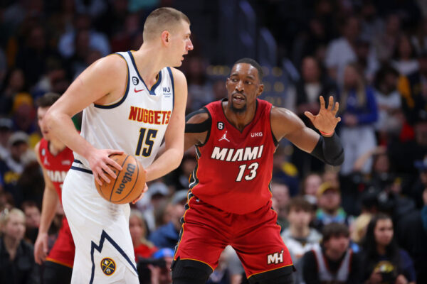 DENVER, CO - DECEMBER 30: Bam Adebayo #13 of the Miami Heat defends Nikola Jokic #15 of the Denver Nuggets during the first quarter at Ball Arena on December 30, 2022 in Denver, Colorado.