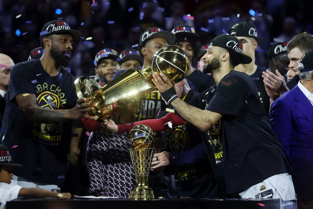 DENVER, COLORADO - JUNE 12: The Denver Nuggets celebrate with the Larry O'Brien Championship Trophy after a 94-89 victory against the Miami Heat in Game Five of the 2023 NBA Finals to win the NBA Championship at Ball Arena on June 12, 2023 in Denver, Colorado.