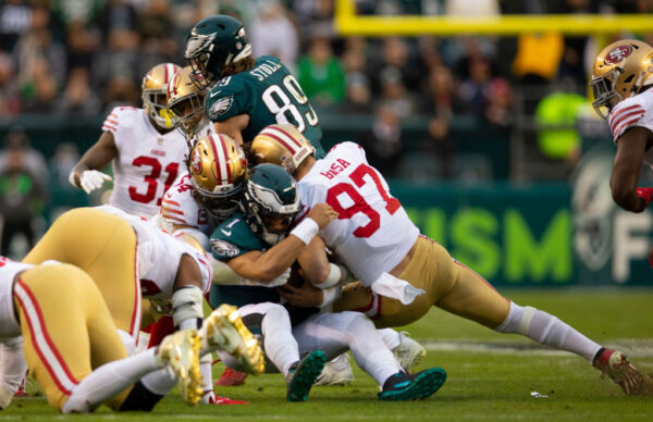 PHILADELPHIA, PA - JANUARY 29: Fred Warner #54 and Nick Bosa #97 of the San Francisco 49ers tackle Jalen Hurts #1 of the Philadelphia Eagles during the NFC Championship playoff game at Lincoln Financial Field on January 29, 2023 in Philadelphia, Pennsylvania. The Eagles defeated the 49ers 31-7.