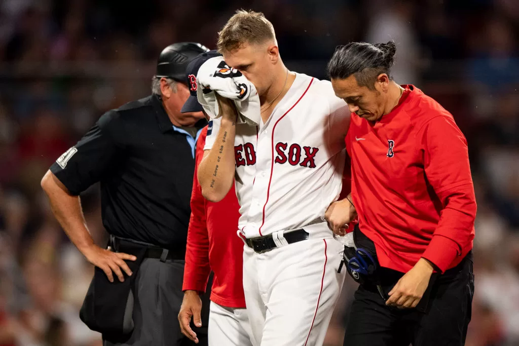 BOSTON, MA - JUNE 16: Tanner Houck #89 of the Boston Red Sox exits the game after being hit in the face with a line drive during the fifth inning against the New York Yankees at Fenway Park on June 16, 2023 in Boston, Massachusetts.