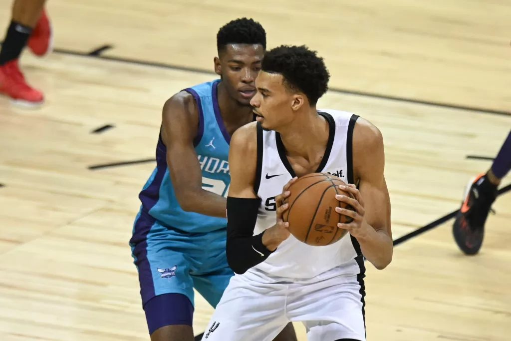 LAS VEGAS, NEVADA - JULY 07: Brandon Miller #24 of the Charlotte Hornets defends against Victor Wembanyama #1 of the San Antonio Spurs during the fourth quarter at the Thomas & Mack Center on July 07, 2023 in Las Vegas, Nevada